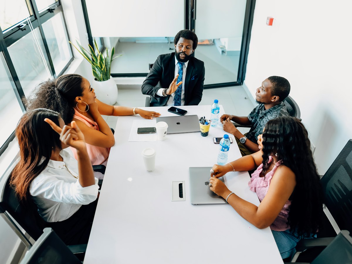 A leadership team in discussion around a boardroom table